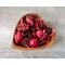 Handmade wooden bowl in a heart shape, displaying aromatic apple cinnamon potpourri against a rustic grey background